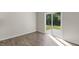 Living room with hardwood floors and sliding glass door to the backyard at 137 Pisgah St, Sanford, NC 27330