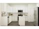 Modern kitchen with stainless steel appliances, white cabinets, and a kitchen island, providing ample counter space at 144 Digging Time Ave, Princeton, NC 27569
