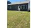 Newly sodded backyard with a patio and exterior door on a grey home at 144 N Keatts Winner Ct, Wilson's Mills, NC 27520