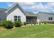 A beautiful backyard with a screened-in porch, lush green lawn, and well-maintained landscaping at 149 Ivory Ln, Raleigh, NC 27610