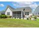 Attractive home exterior boasts a screened-in porch and patio surrounded by lush landscaping and flower planters at 149 Ivory Ln, Raleigh, NC 27610