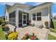 Charming backyard with a screened porch, patio area, and colorful flower arrangements at 149 Ivory Ln, Raleigh, NC 27610