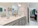 Bright bathroom with dual sinks, a large mirror, and access to the bedroom at 149 Ivory Ln, Raleigh, NC 27610