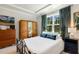 Cozy bedroom features a metal frame bed, wardrobe, and window with blue curtains at 149 Ivory Ln, Raleigh, NC 27610
