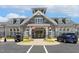 A stately clubhouse with stone facade, flags, ample parking and welcoming entrance at 149 Ivory Ln, Raleigh, NC 27610