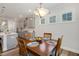 Cozy dining area featuring a wooden table set, pendant lighting, and a view of the modern kitchen at 149 Ivory Ln, Raleigh, NC 27610
