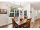 Well-lit dining space with a wood table, featuring natural light and elegant window treatments at 149 Ivory Ln, Raleigh, NC 27610
