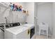 Functional laundry room with a washer, dryer, utility sink, and wire shelving for storage at 149 Ivory Ln, Raleigh, NC 27610