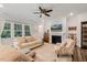 Bright living room with a fireplace, large windows, and comfortable seating at 149 Ivory Ln, Raleigh, NC 27610