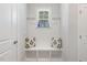 Bright mudroom features a built-in bench with storage, decorative pillows, and a window shelf showcasing colorful bottles at 149 Ivory Ln, Raleigh, NC 27610