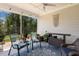 Inviting screened porch with comfortable seating, ceiling fan, and views of the lush greenery at 149 Ivory Ln, Raleigh, NC 27610