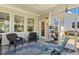 Relaxing screened porch features wicker chairs, a decorative rug, and views of the well-manicured backyard at 149 Ivory Ln, Raleigh, NC 27610