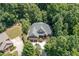Stunning aerial view of a traditional home with mature trees, a sprawling lawn, and an extended driveway at 150 Luxorwind Dr, Garner, NC 27529