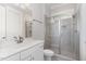 Modern bathroom with a glass-enclosed shower, white vanity, and marble countertops at 150 Luxorwind Dr, Garner, NC 27529