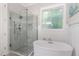 This bathroom offers a glass shower, soaking tub, and a decorative window at 150 Luxorwind Dr, Garner, NC 27529