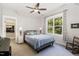 Bedroom featuring a ceiling fan, large window, and closet access at 150 Luxorwind Dr, Garner, NC 27529