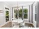 Charming breakfast nook with a round table, white chairs, and a large window with backyard views at 150 Luxorwind Dr, Garner, NC 27529
