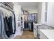Walk-in closet featuring built-in shelving, hanging rods, and hardwood floors at 150 Luxorwind Dr, Garner, NC 27529