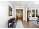 Elegant foyer featuring hardwood floors, a wooden console table, mirror, and a grandfather clock at 150 Luxorwind Dr, Garner, NC 27529