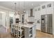 Modern kitchen featuring a large island with seating, granite countertops, and stainless steel appliances at 150 Luxorwind Dr, Garner, NC 27529