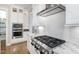 Close-up of a modern kitchen with stainless steel range, white cabinets, and granite countertops at 150 Luxorwind Dr, Garner, NC 27529