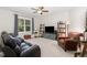 Living room featuring a ceiling fan, built-in bookshelves, and comfortable seating at 150 Luxorwind Dr, Garner, NC 27529