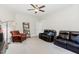 Living room featuring ceiling fan, leather furniture, and an open layout at 150 Luxorwind Dr, Garner, NC 27529