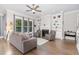 Comfortable living room featuring a fireplace, built-in shelves, and hardwood floors at 150 Luxorwind Dr, Garner, NC 27529