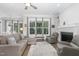 Bright living room with large windows, comfortable seating, hardwood floors, and fireplace at 150 Luxorwind Dr, Garner, NC 27529