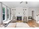 Bright and airy living room with a fireplace, built-in shelving, and hardwood flooring at 150 Luxorwind Dr, Garner, NC 27529