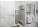 Mudroom featuring gray shiplap, built-in bench and shelving leading to the laundry room at 150 Luxorwind Dr, Garner, NC 27529