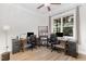 Well-lit home office with two desks, built-in shelves, and a large window overlooking the backyard at 150 Luxorwind Dr, Garner, NC 27529