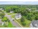 Aerial shot of tree lined street with a light blue house, showing the trampoline in the backyard at 1505 Mclaurin Ln, Fuquay Varina, NC 27526
