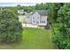 An aerial shot shows the home's spacious backyard with a basketball court and trampoline at 1505 Mclaurin Ln, Fuquay Varina, NC 27526