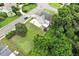 Aerial view of a light blue home with a spacious yard, basketball court, and mature trees at 1505 Mclaurin Ln, Fuquay Varina, NC 27526