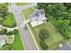 Aerial view of a light blue home with a well-maintained lawn, basketball court, and trampoline at 1505 Mclaurin Ln, Fuquay Varina, NC 27526