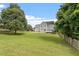 Spacious backyard with lush green lawn, mature trees, and a fenced perimeter at 1505 Mclaurin Ln, Fuquay Varina, NC 27526