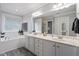 Bright bathroom featuring double vanity, a soaking tub, and large mirrors at 1505 Mclaurin Ln, Fuquay Varina, NC 27526