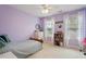 Bedroom featuring lavender walls and a cozy bed at 1505 Mclaurin Ln, Fuquay Varina, NC 27526