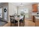 Inviting dining area with bright natural light, modern pendant fixture, and wooden floors at 1505 Mclaurin Ln, Fuquay Varina, NC 27526