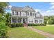 Traditional two-story home with manicured lawn, inviting front porch, and symmetrical window placement at 1505 Mclaurin Ln, Fuquay Varina, NC 27526