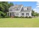 Traditional two-story home with manicured lawn, inviting front porch, and symmetrical window placement at 1505 Mclaurin Ln, Fuquay Varina, NC 27526