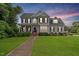 Charming two-story home features a well-manicured lawn, inviting front porch, and classic architectural details at 1505 Mclaurin Ln, Fuquay Varina, NC 27526