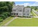 Aerial view of lovely two-story home with front yard and sidewalk to street at 1505 Mclaurin Ln, Fuquay Varina, NC 27526