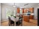Well-appointed kitchen with island, stainless appliances, and dining area at 1505 Mclaurin Ln, Fuquay Varina, NC 27526