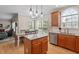 Bright kitchen featuring granite countertops, an island, pendant lighting, and stainless steel appliances at 1505 Mclaurin Ln, Fuquay Varina, NC 27526