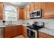 Well-lit kitchen with granite countertops, stainless steel appliances including oven and microwave at 1505 Mclaurin Ln, Fuquay Varina, NC 27526