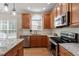 Gourmet kitchen with granite countertops, stainless appliances, and light wood cabinetry at 1505 Mclaurin Ln, Fuquay Varina, NC 27526