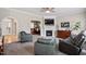 Open concept living area featuring fireplace, hardwood floors, and stylish furniture at 1505 Mclaurin Ln, Fuquay Varina, NC 27526