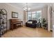 Cozy living room with large windows, hardwood floors, comfortable seating, and a piano at 1505 Mclaurin Ln, Fuquay Varina, NC 27526
